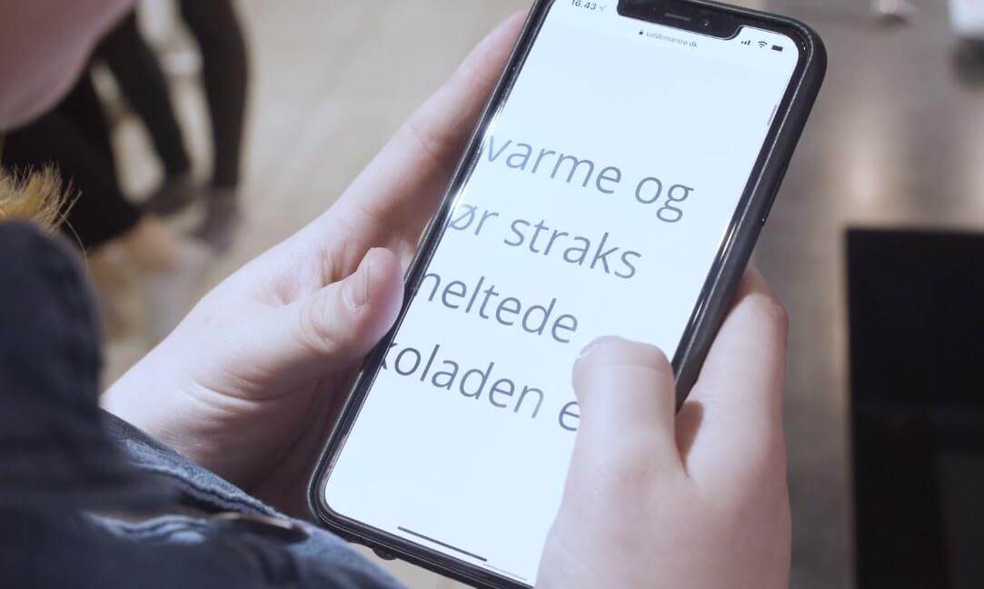 Juliane zoomer ind på tekst på sin mobil
