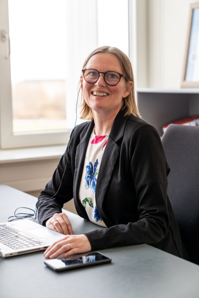 Diana sidder smilende på sit kontor