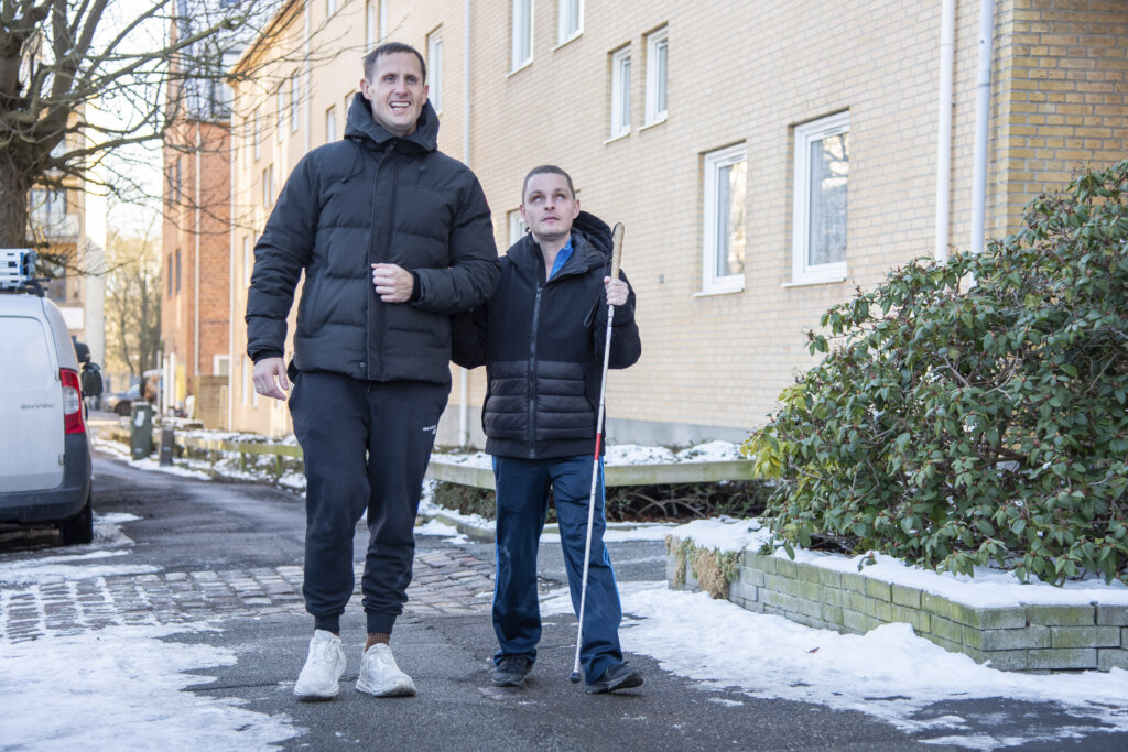 Benjamin Hav gover en arm til Nicklas, da de er ude at gå. Nicklas har sin blindestok i den anden hånd