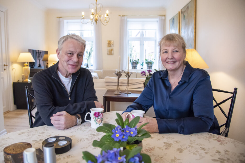 Ægteparret Helle og Henrik sidder ved spisebordet og drikker kaffe