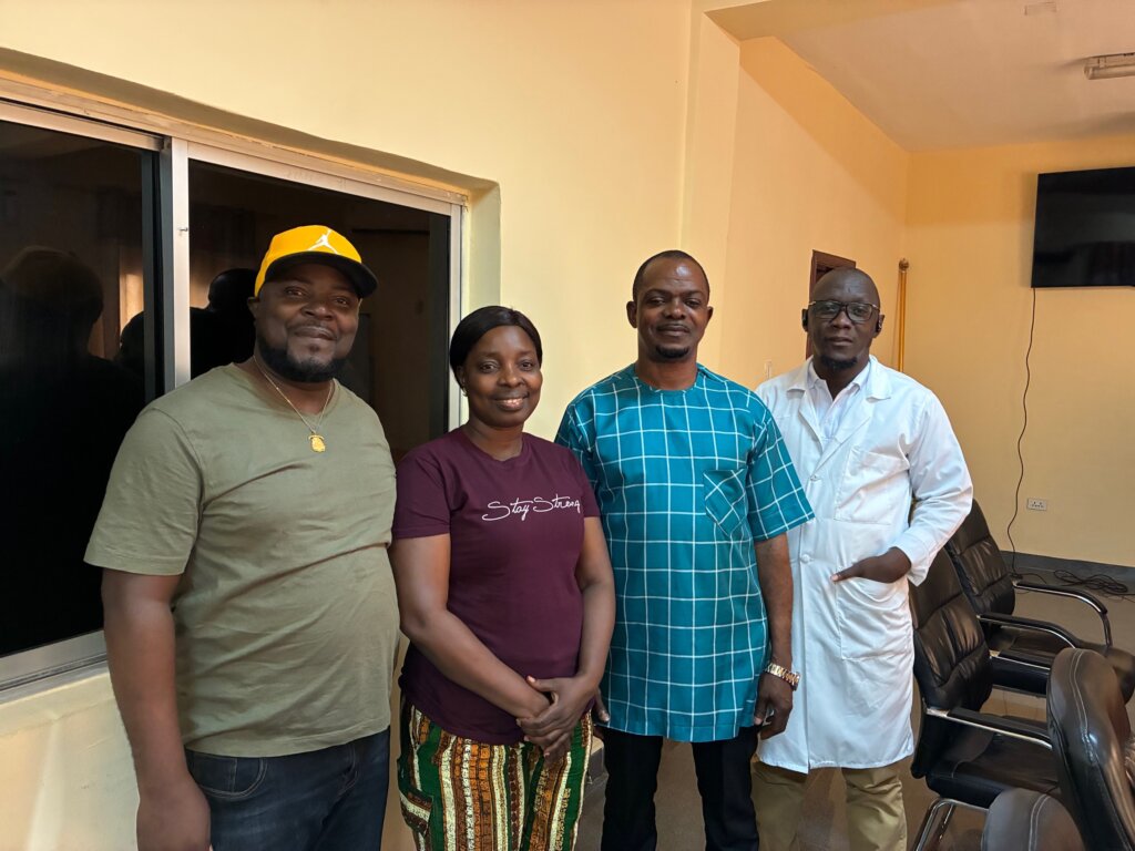 Billedet viser 4 mennesker, 1 kvinde og 3 mænd som står og smiler hen mod kameraet. 