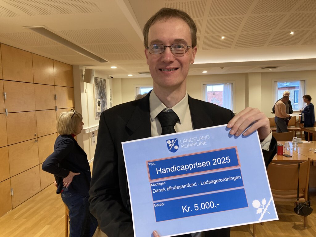 Erik Vind Frost står med diplomet på Handicapprisen
